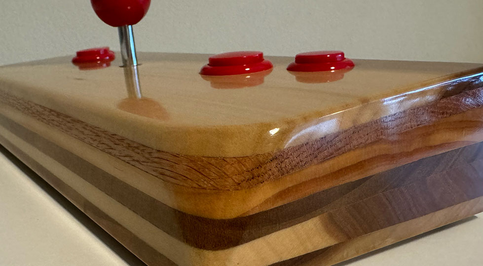 photograph of a wooden video game joystick