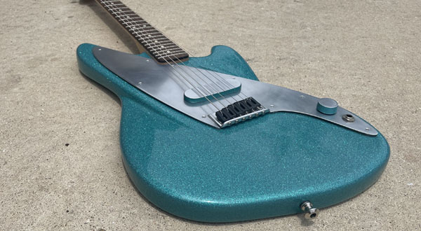 photograph of a green electric guitar