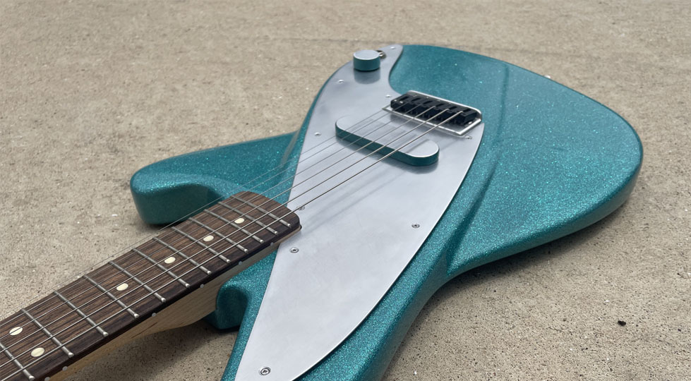 Photograph of a turqoise electric guitar