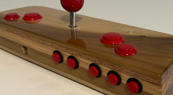 Photograph of a wooden video game joystick