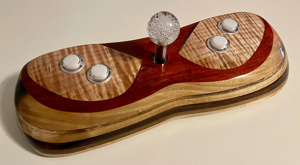 Photograph of a wooden video game joystick